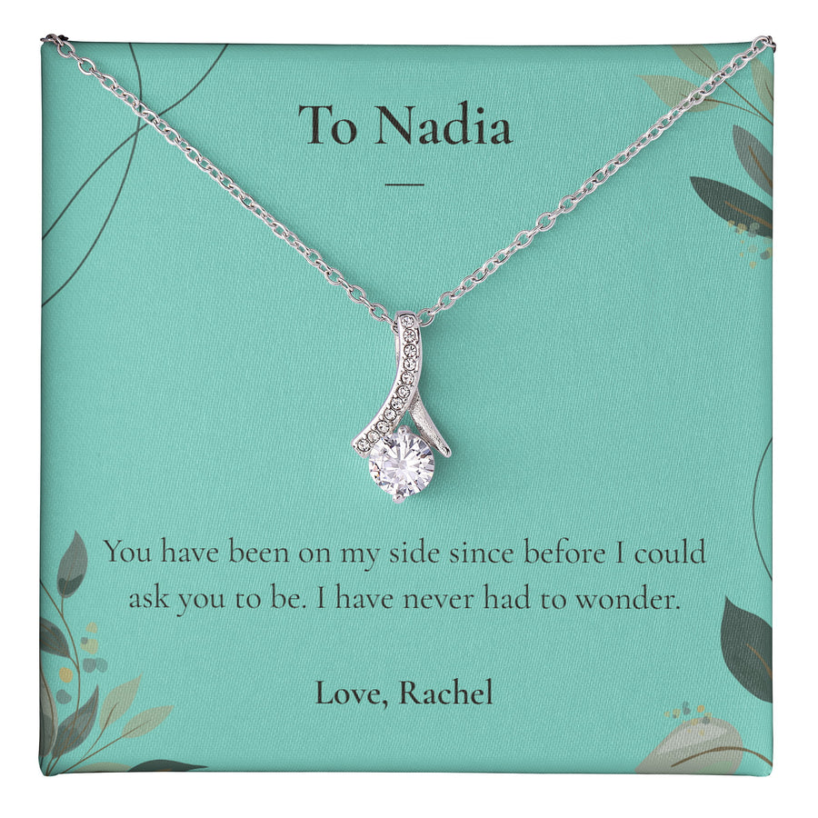 Alluring Beauty Necklace lying on a personalised message card addressed to Nadia.