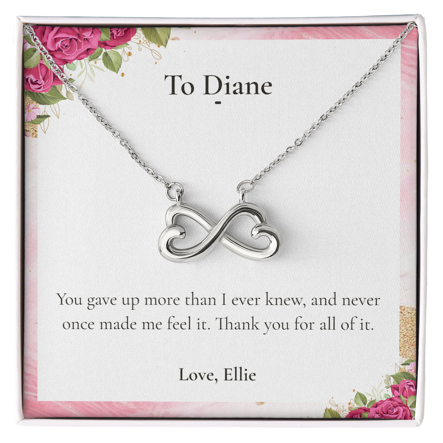 Silver Endless Love Necklace lying on a personalised message card addressed to Diane.